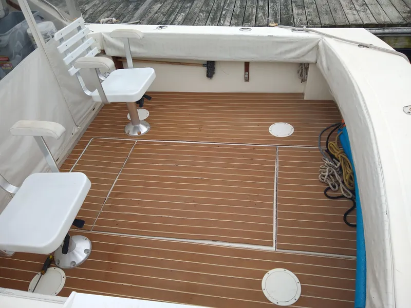 Slide: The Image of 1988 Albemarle 27 Express Fisherman boat deck with seating and wood finish. - 4