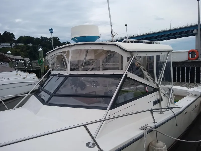 Slide: The Image of 1988 Albemarle 27 Express Fisherman boat docked near a bridge on a cloudy day. - 6