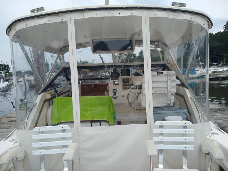 Slide: The Image of 1988 Albemarle 27 Express Fisherman boat with covered cockpit and marina background. - 9