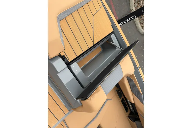 Slide: The Image of 2026 MasterCraft X24 boat interior with tan and gray seating and sleek design. - 18