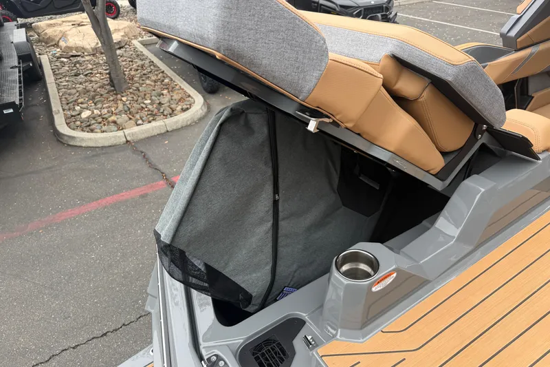 Slide: The Image of 2026 MasterCraft X24 boat with open storage compartment and tan seating. - 21