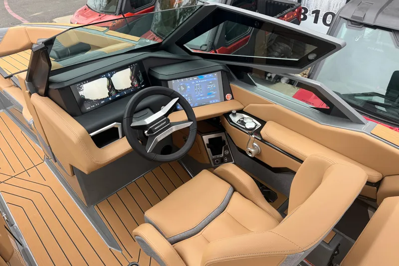 Slide: The Image of 2026 MasterCraft X24 boat interior with modern dashboard and tan leather seating. - 27
