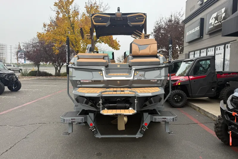 Slide: The Image of 2026 MasterCraft X24 boat displayed outdoors, showcasing rear design and seating. - 3