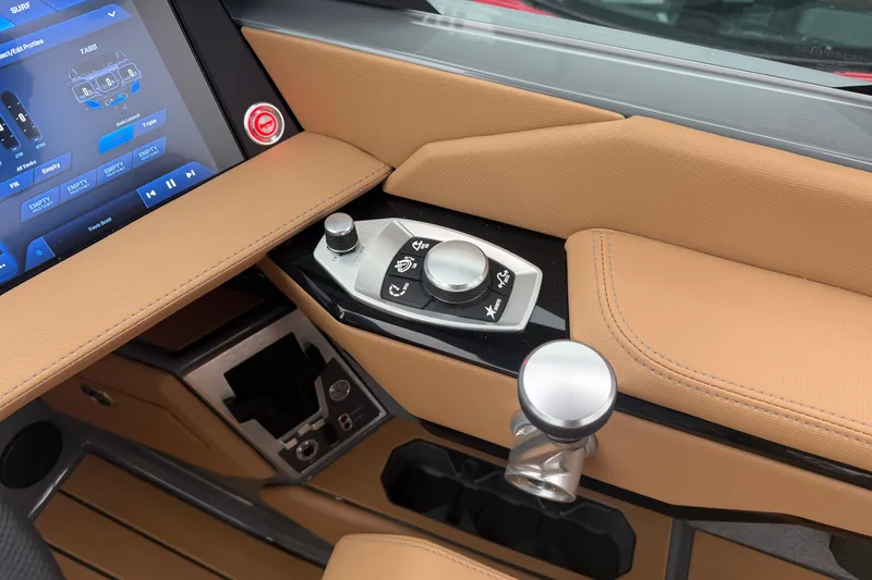 Slide: The Image of 2026 MasterCraft X24 boat interior with touchscreen and control panel, featuring tan leather accents. - 32
