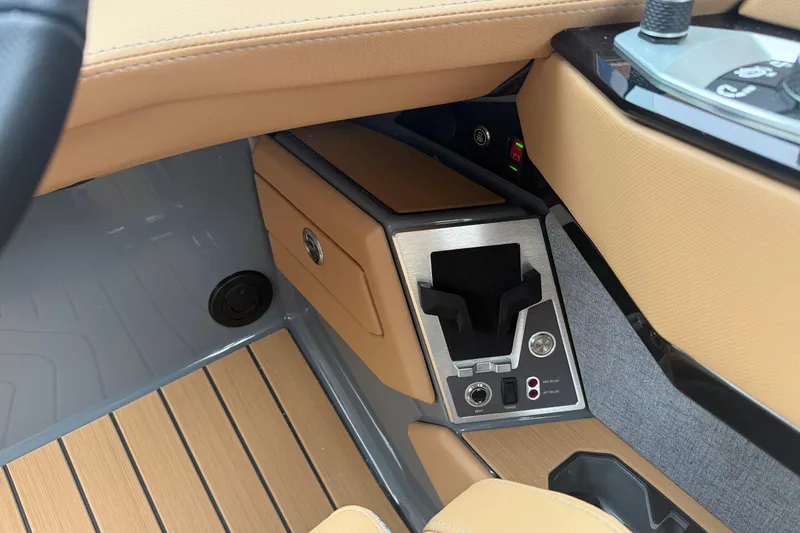 Slide: The Image of 2026 MasterCraft X24 interior console with cup holder and control panel. - 33