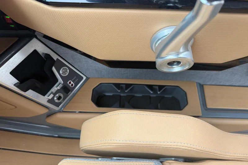 Slide: The Image of 2026 MasterCraft X24 interior detail with cup holders and control panel. - 34