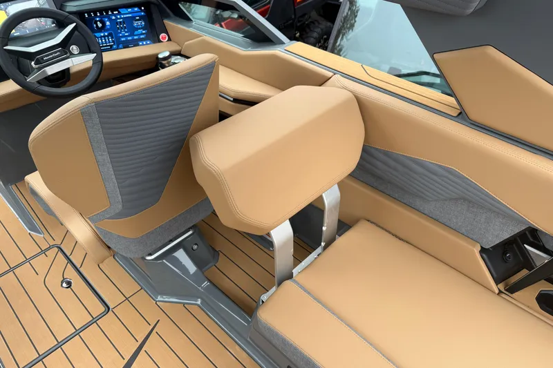 Slide: The Image of 2026 MasterCraft X24 boat interior with tan and gray seating, modern dashboard, and sleek design. - 36