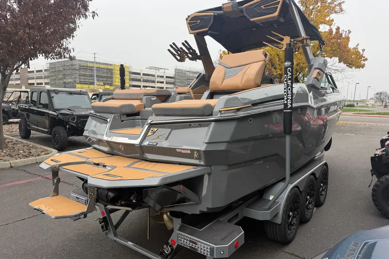 Slide: The Image of 2026 MasterCraft X24 boat on trailer, featuring sleek design and luxurious seating. - 4