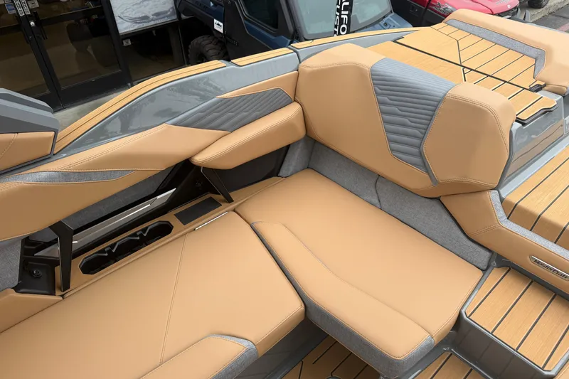 Slide: The Image of 2026 MasterCraft X24 boat interior with tan and gray seating, showcasing luxury design. - 42