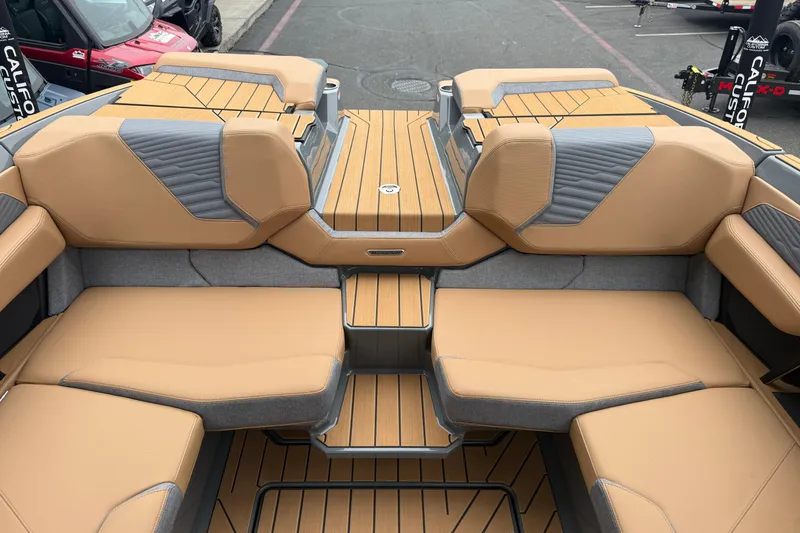 Slide: The Image of 2026 MasterCraft X24 boat interior with tan and gray seating, showcasing luxury design. - 44