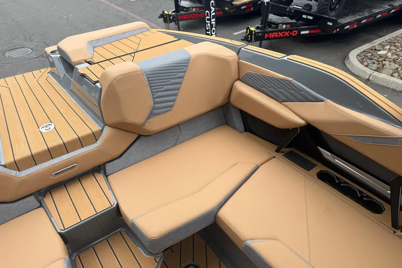 Slide: The Image of 2026 MasterCraft X24 boat interior with tan and gray seating, showcasing luxury design. - 46