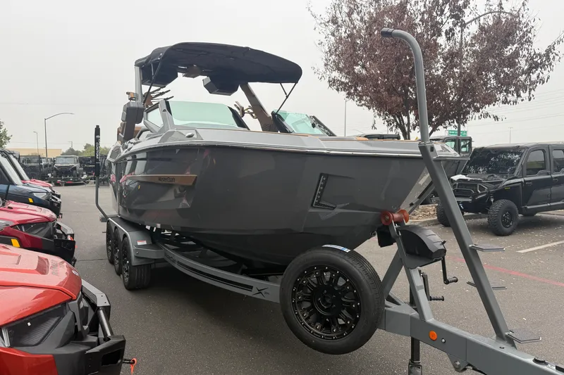 Slide: The Image of 2026 MasterCraft X24 boat on trailer in parking lot. - 5