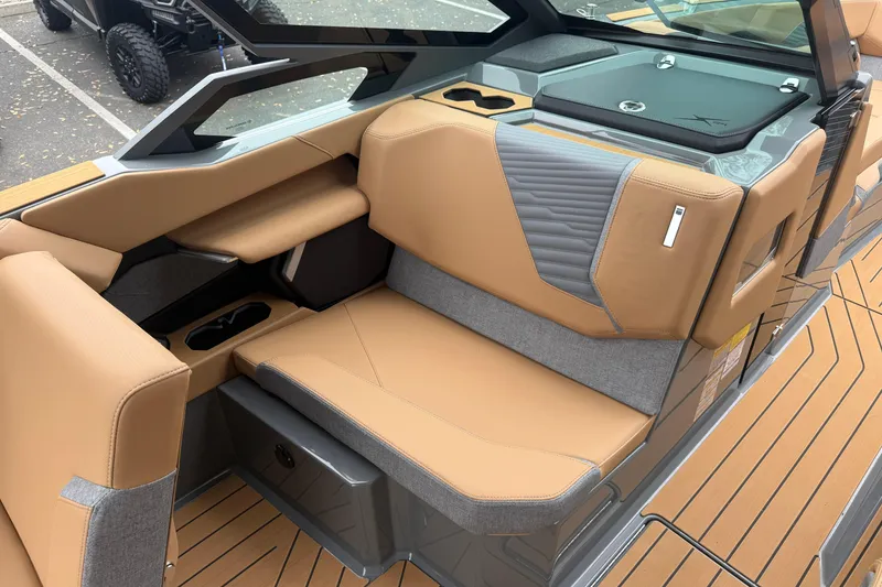 Slide: The Image of 2026 MasterCraft X24 boat interior with tan and gray seating, modern design. - 54
