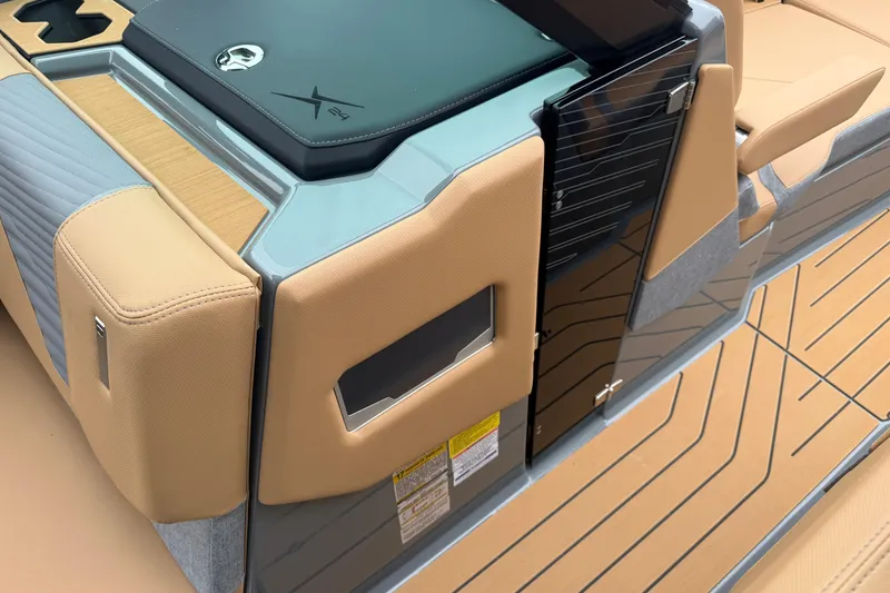 Slide: The Image of 2026 MasterCraft X24 boat interior with tan upholstery and sleek design elements. - 56