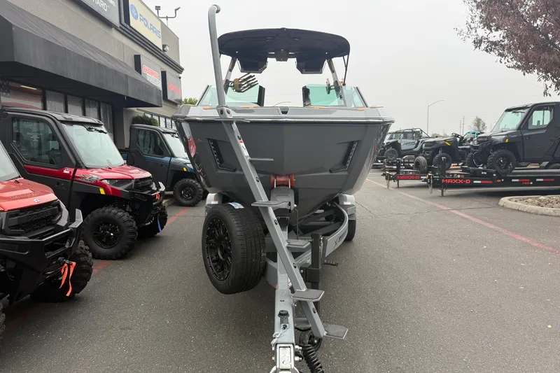 Slide: The Image of 2026 MasterCraft X24 boat on trailer, surrounded by off-road vehicles. - 6