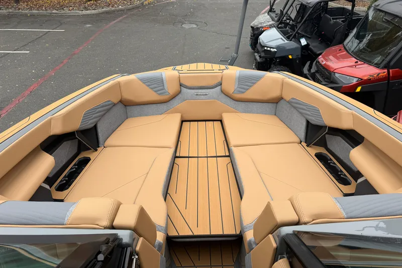 Slide: The Image of 2026 MasterCraft X24 boat interior with tan and gray seating, showcasing luxury design. - 60