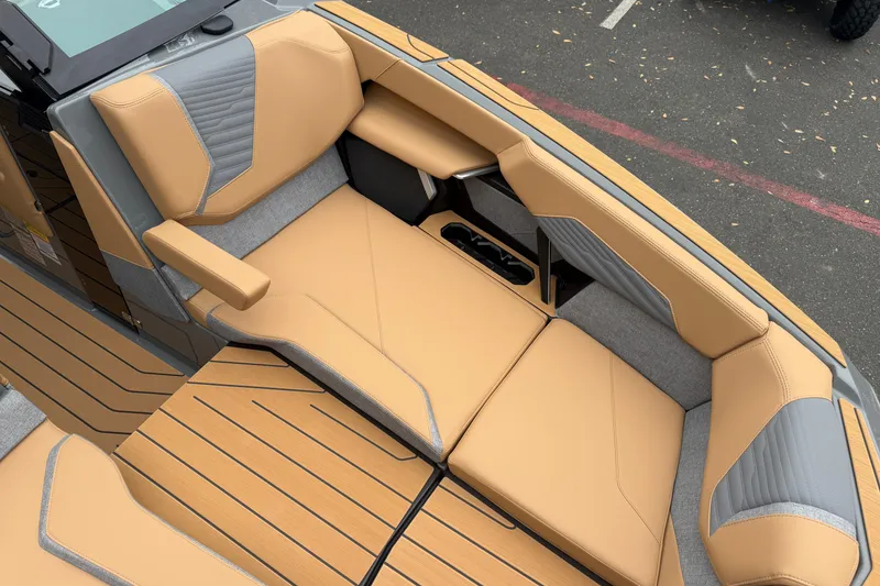 Slide: The Image of 2026 MasterCraft X24 boat interior with tan and gray seating, showcasing luxury design. - 61