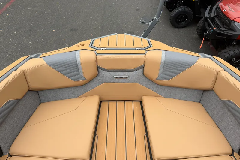 Slide: The Image of 2026 MasterCraft X24 boat interior with tan and gray seating, showcasing luxury design. - 65