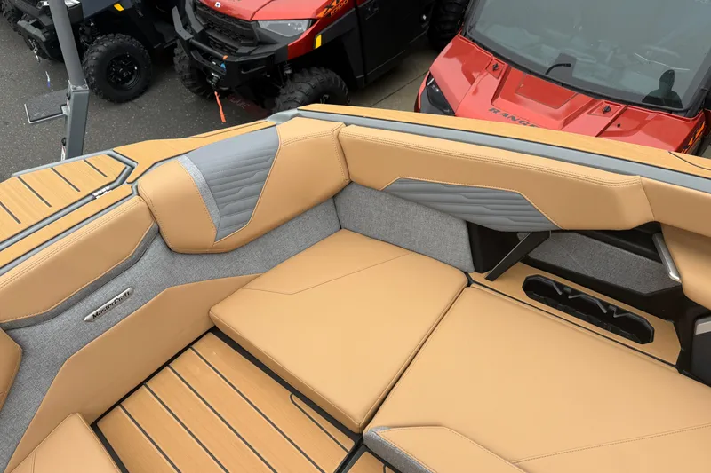 Slide: The Image of 2026 MasterCraft X24 boat interior with tan and gray seating, showcasing luxury design. - 66