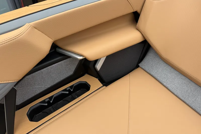 Slide: The Image of 2026 MasterCraft X24 interior with tan upholstery and integrated cup holder. - 68