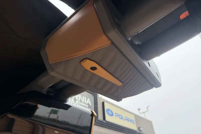 Slide: The Image of 2026 MasterCraft X24 interior detail with tan and gray upholstery, showcasing sleek design elements. - 77