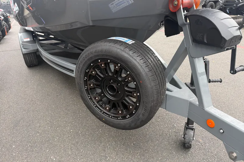 Slide: The Image of Trailer wheel of 2026 MasterCraft X24 boat on pavement. - 9