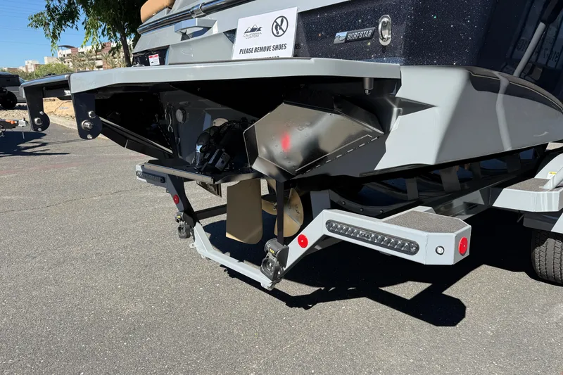 Slide: The Image of 2026 MasterCraft XT24 boat trailer hitch and propeller detail in sunlight. - 11