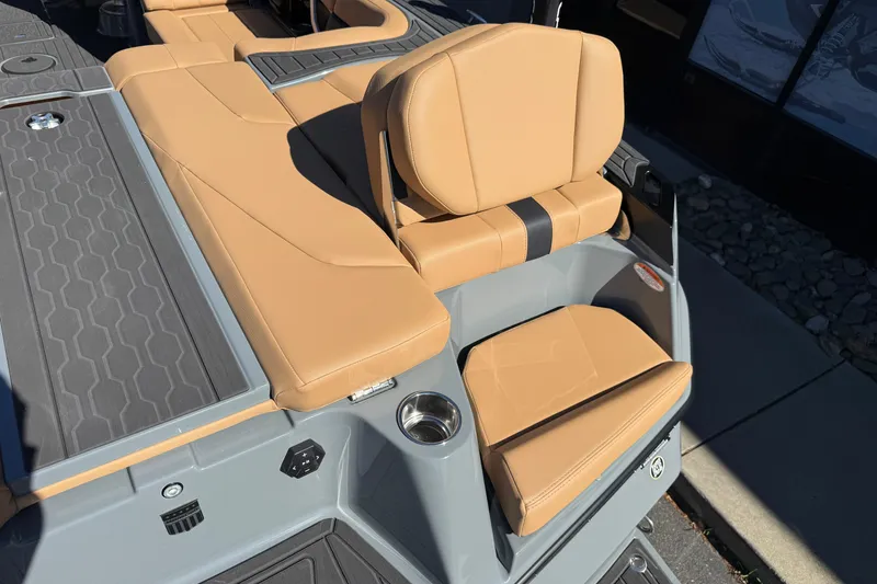 Slide: The Image of 2026 MasterCraft XT24 boat interior with tan seating and gray flooring. - 14