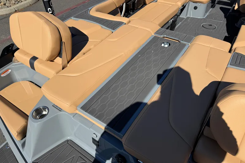 Slide: The Image of 2026 MasterCraft XT24 boat interior with tan seating and gray flooring. - 16