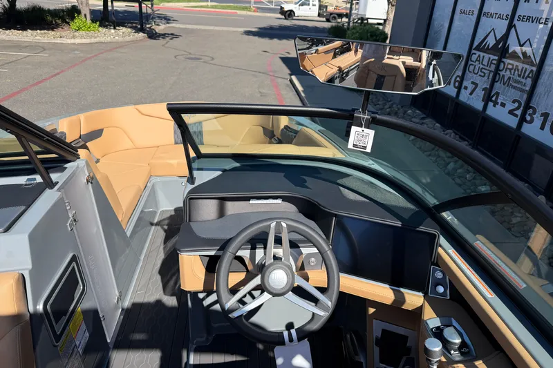 Slide: The Image of 2026 MasterCraft XT24 boat interior with modern dashboard and tan seating. - 17