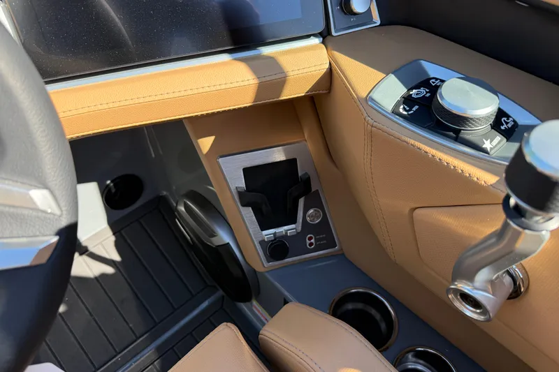 Slide: The Image of 2026 MasterCraft XT24 boat interior with tan leather and modern controls. - 18