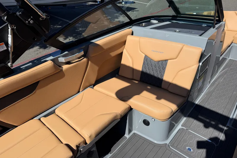 Slide: The Image of 2026 MasterCraft XT24 boat interior with tan leather seating and modern design. - 26