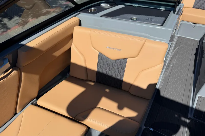 Slide: The Image of 2026 MasterCraft XT24 boat interior with tan and gray seating. - 27