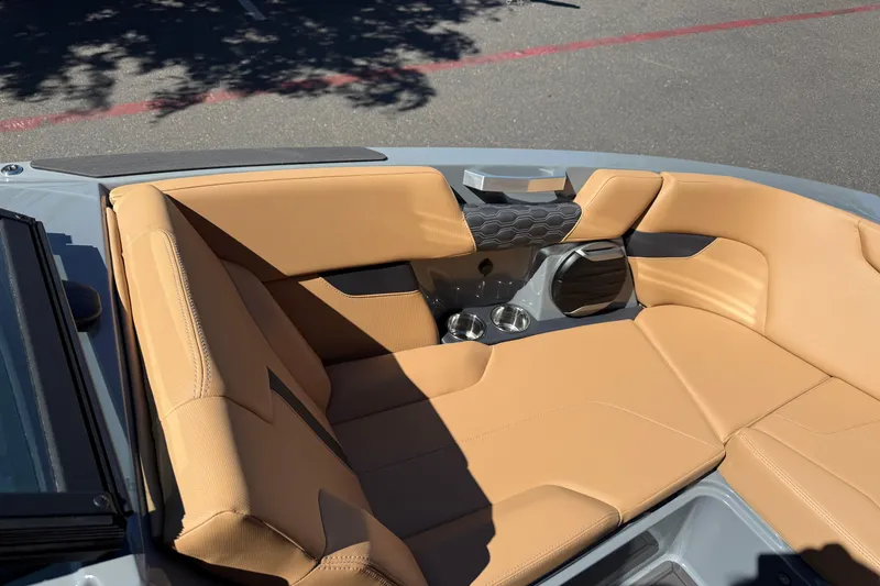 Slide: The Image of 2026 MasterCraft XT24 boat interior with tan leather seating and cup holders. - 29