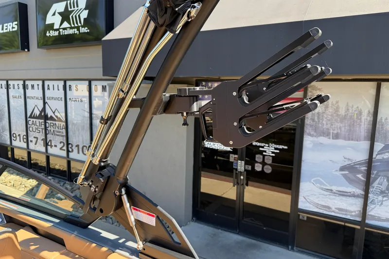 Slide: The Image of 2026 MasterCraft XT24 boat tower with wakeboard rack at dealership. - 32