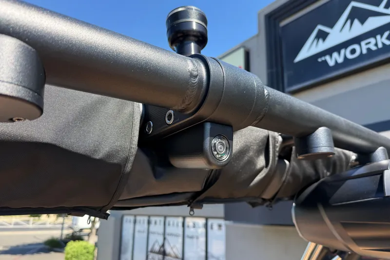 Slide: The Image of Close-up of a 2026 MasterCraft XT24 boat's camera and mount under a clear blue sky. - 34