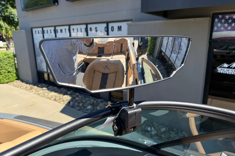 Slide: The Image of Rearview mirror of 2026 MasterCraft XT24 boat reflecting interior and exterior view. - 35