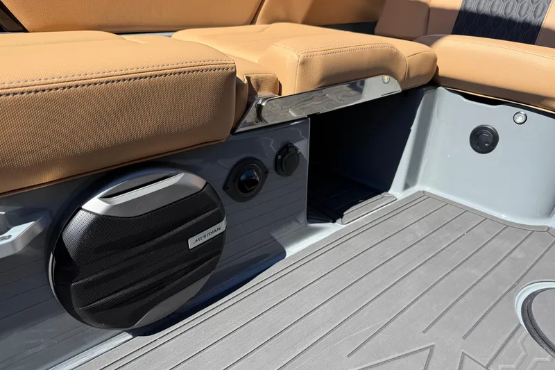 Slide: The Image of 2026 MasterCraft XT24 boat interior with tan seating and Meridian speaker system. - 36