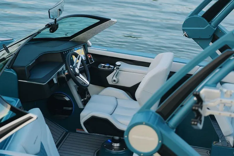 Slide: The Image of Manufacturer Provided Image: 2026 MasterCraft XT24 boat interior with modern dashboard and steering, overlooking water. - 5