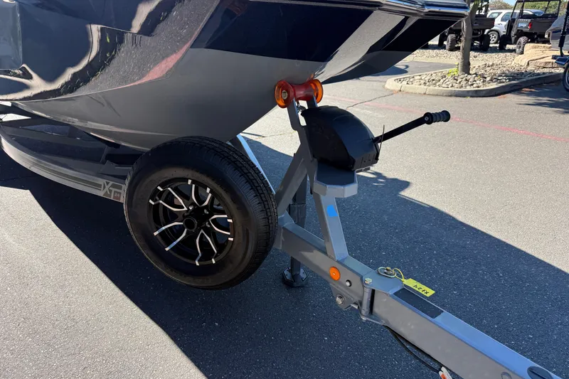 Slide: The Image of 2026 MasterCraft XT24 boat trailer with sleek black wheel design. - 9