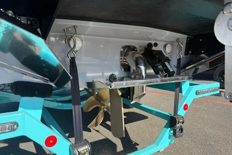 Slide: The Image of 2026 MasterCraft XT23 boat underside showing propeller and trailer details. - 12