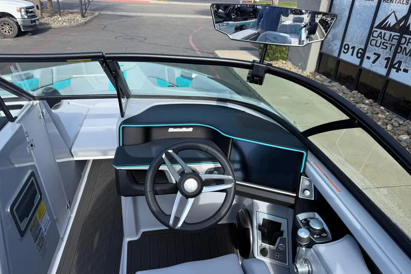 Slide: The Image of 2026 MasterCraft XT23 boat interior with modern dashboard and steering wheel design. - 13