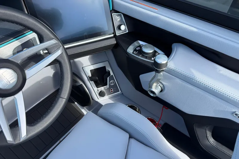 Slide: The Image of 2026 MasterCraft XT23 boat interior with steering wheel and control panel. - 14