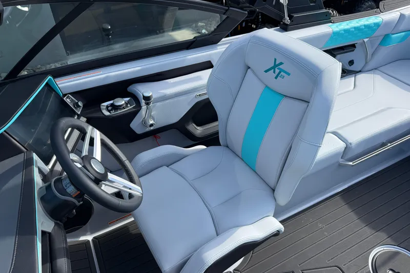 Slide: The Image of 2026 MasterCraft XT23 boat interior with modern steering and stylish seating. - 15