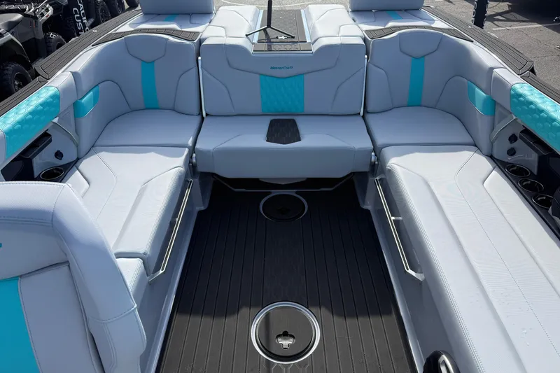 Slide: The Image of 2026 MasterCraft XT23 boat interior with sleek white and turquoise seating. - 18
