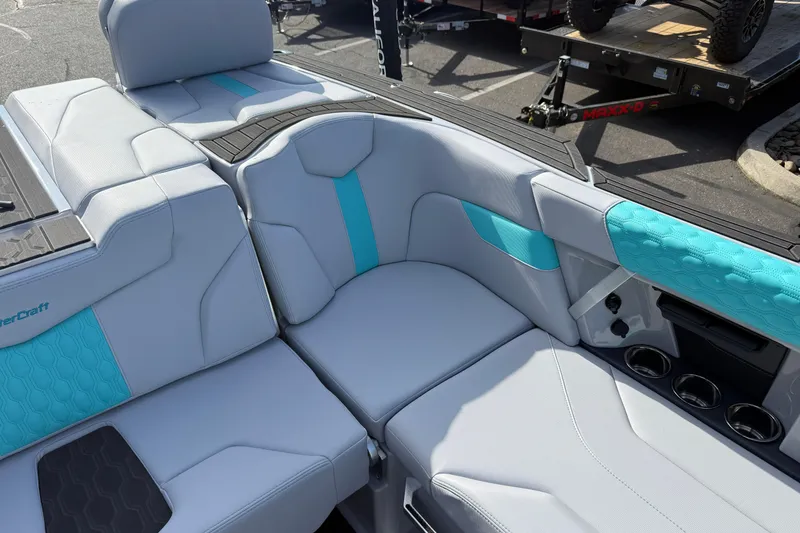 Slide: The Image of 2026 MasterCraft XT23 boat interior with gray and turquoise seating, showcasing modern design. - 19
