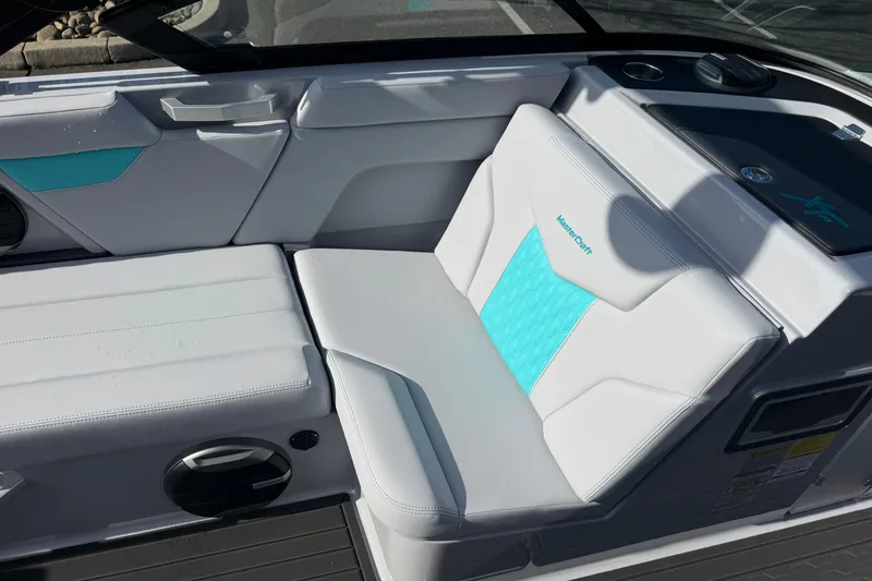 Slide: The Image of 2026 MasterCraft XT23 boat interior with white and turquoise seating. - 21
