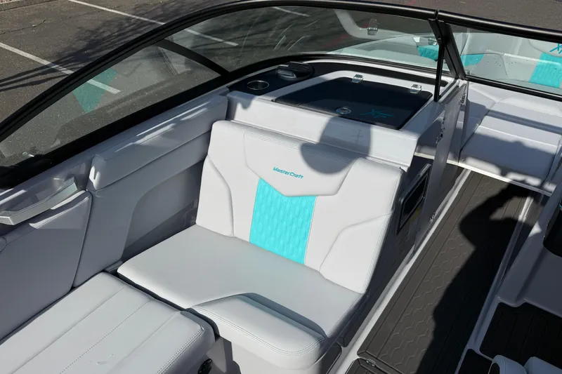 Slide: The Image of 2026 MasterCraft XT23 boat interior with white and teal seating, showcasing modern design. - 22