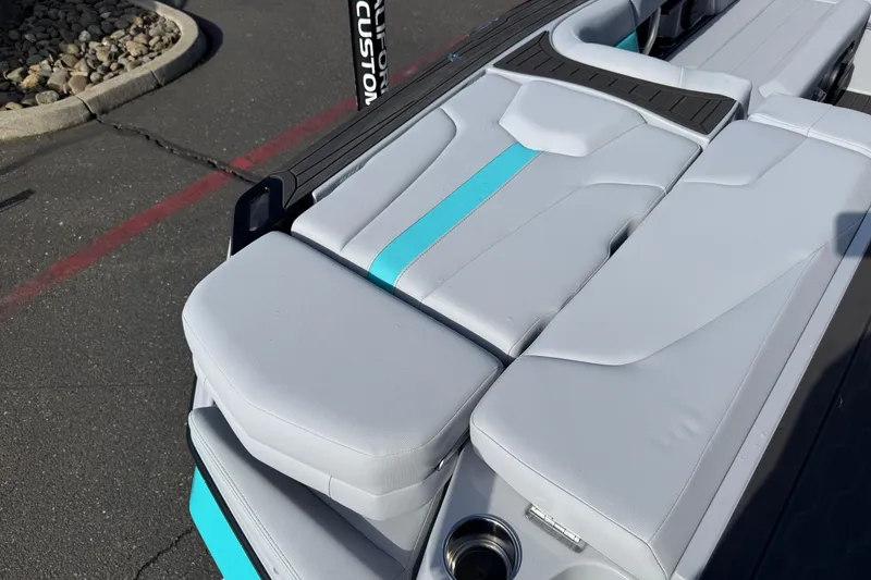 Slide: The Image of 2026 MasterCraft XT23 boat interior with sleek white and turquoise seating. - 32