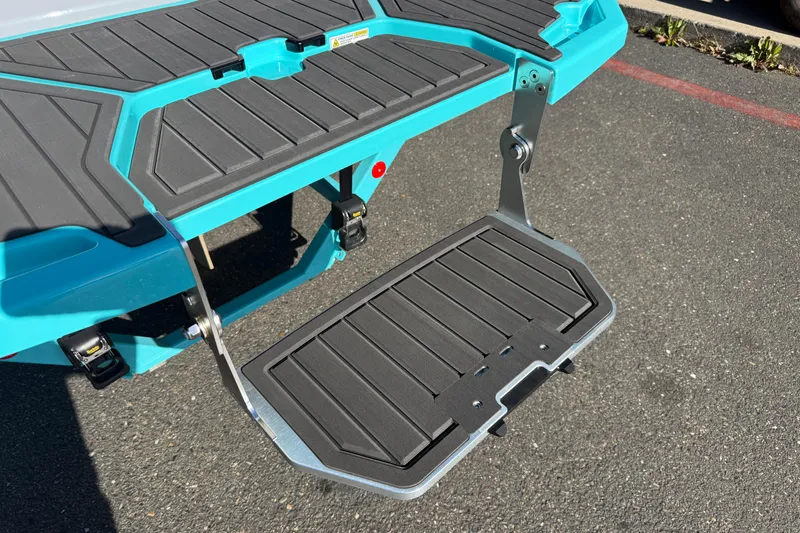 Slide: The Image of 2026 MasterCraft XT23 boat swim platform with teal and black design. - 37